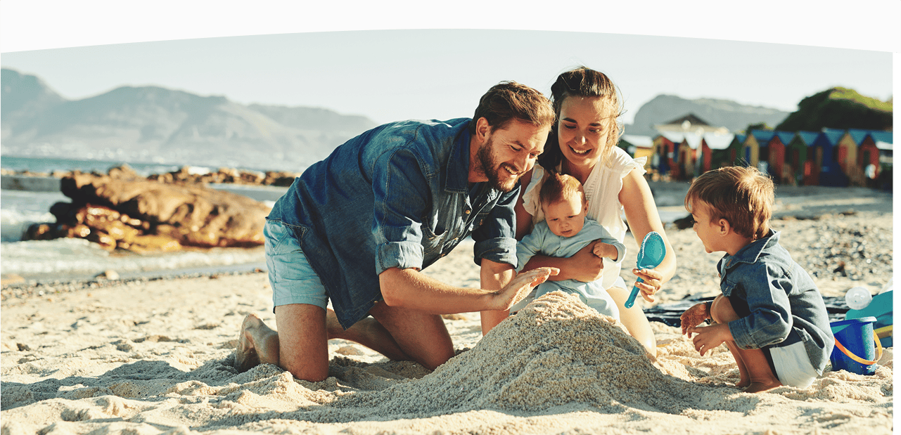 family playing at the beach